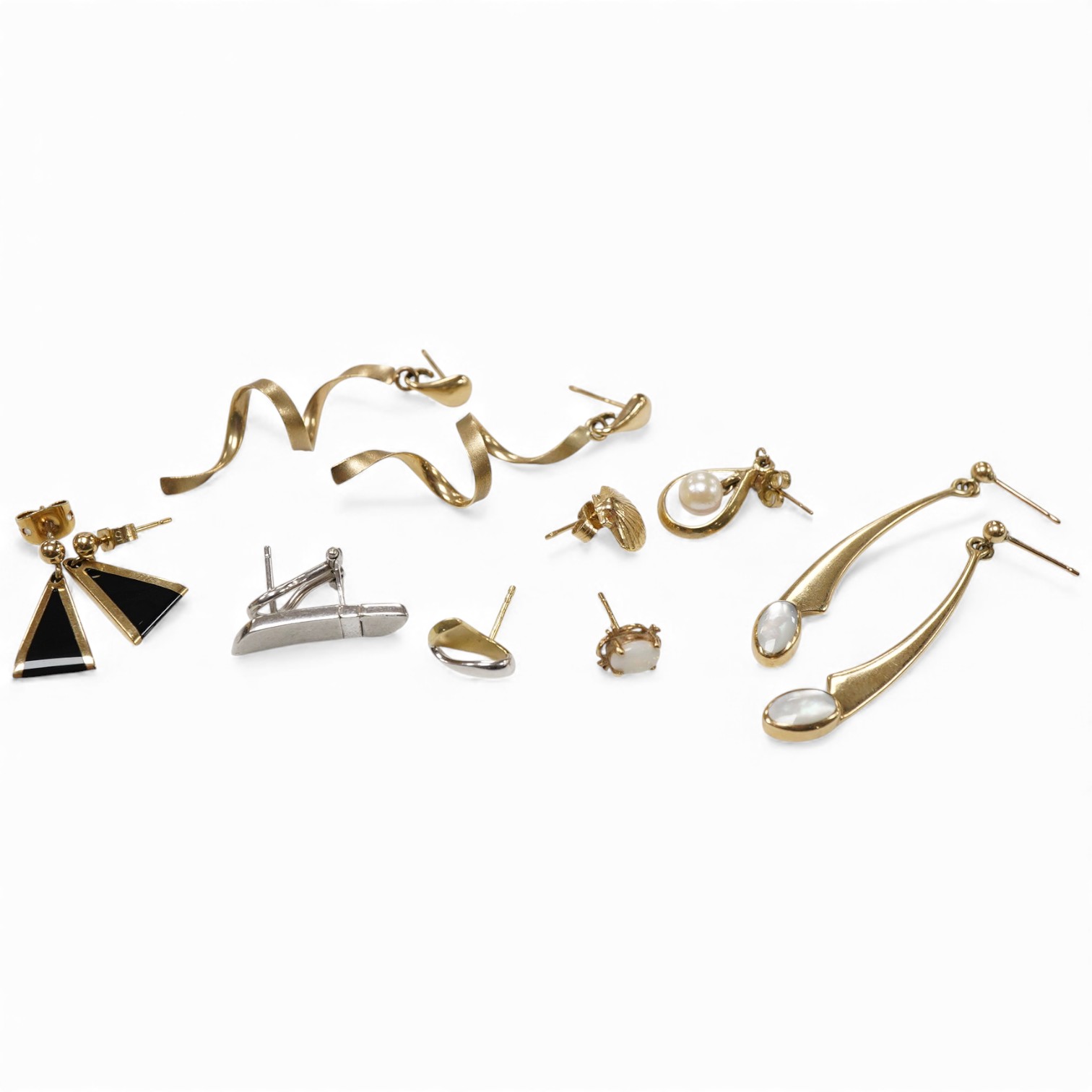 Three modern pairs of 9ct gold earrings, including spiral, triangular and moonstone set, together with five odd earrings.